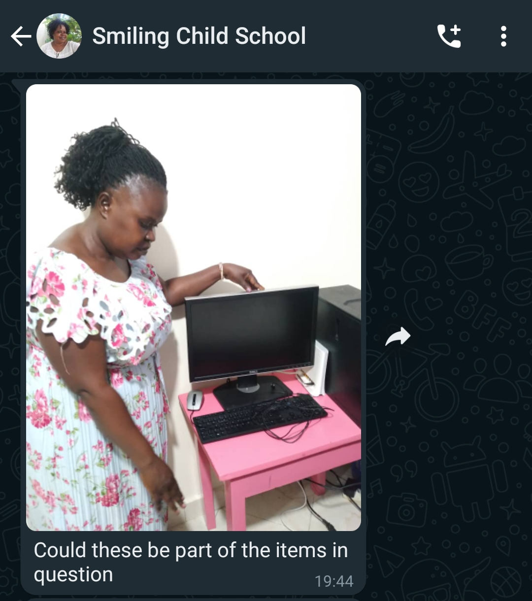 Sgt. Beatrice Gonza of Kira Road police standing next to a stolen computer